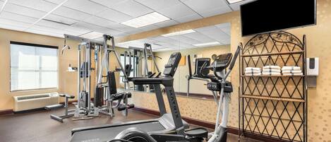 A gym with treadmills, ellipticals, and weight machines.