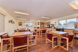 Enjoy group dining in a spacious room with comfortable seating and beautiful views of the surrounding area.