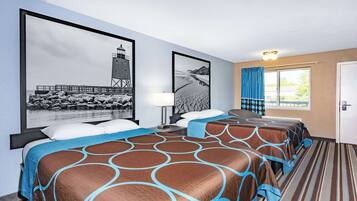 A hotel room with two beds, a large framed picture of a lighthouse, a window with curtains, and a striped carpet.