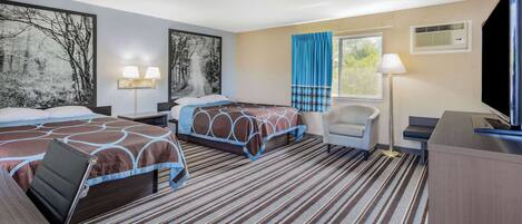 A hotel room with two beds, a desk, a chair, a large window with curtains, and artwork on the walls.