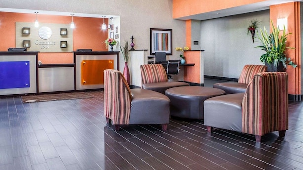 A hotel lobby with a reception desk, seating area, and a large window. - Comfort Inn Lees Summit @ Hwy 50 & Hwy 291 (Lee's Summit)