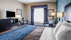 A hotel room with a bed, a desk with a chair, a television, and a window with curtains. - Comfort Inn Lees Summit @ Hwy 50 & Hwy 291 (Lee's Summit)