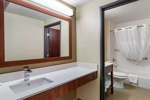 A bathroom with a white sink, a mirror, a toilet, and a shower curtain. - Comfort Inn & Suites South Hill I-85 (South Hill)