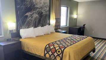 Une chambre d’hôtel comprenant un lit, des tables de chevet, une grande œuvre d’art murale, une fenêtre avec des rideaux et un tapis à rayures.