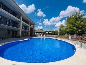Seasonal outdoor pool, open 10:00 AM to 11:00 PM, pool umbrellas