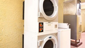 A stacked washer and dryer unit with a control panel and a vent. - Super 8 by Wyndham Defuniak Springs (De Funiak Springs)
