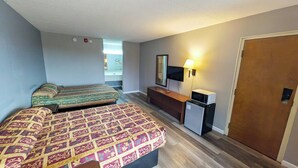 A hotel room with two beds, a small kitchenette, a TV, and a door. - Inn of Loudon (Loudon)