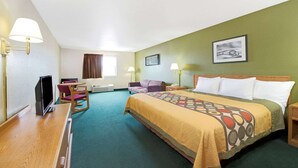 A hotel room with a bed, a desk, a chair, a couch, and a TV. - Super 8 by Wyndham Bonne Terre (Bonne Terre)