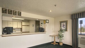 A reception area with a counter, computer, and framed certificates on the wall.