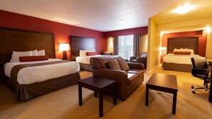 A hotel room with a large bed, a sofa, a desk, and a chair. - The Kanata by BCMInns Invermere (Invermere)