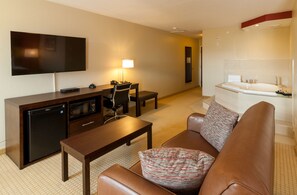 Jacuzzi Suite | Living area | 48-inch TV with cable channels