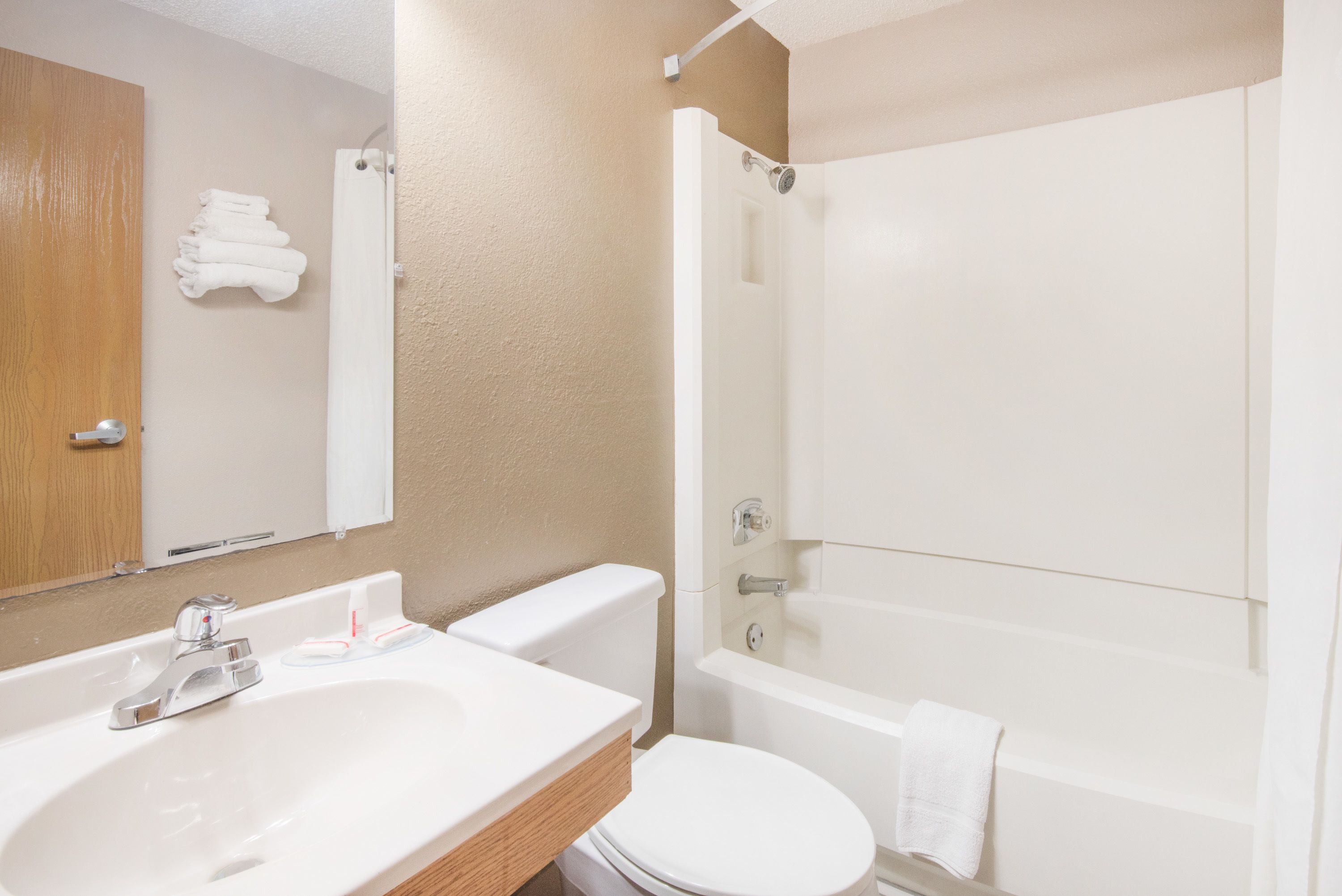 A bathroom with a sink, toilet, and bathtub.