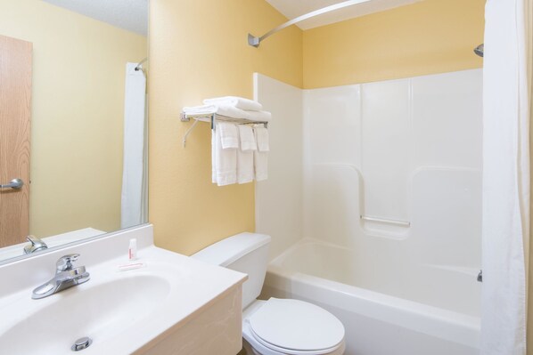 A bathroom with a sink, toilet, and bathtub.