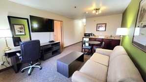 A compact hotel room with a living area, kitchenette, and a flat-screen TV. - Super 8 by Wyndham Portage La Prairie MB (Portage La Prairie)