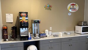 A kitchenette with a coffee machine, microwave, and a trash can. - Super 8 by Wyndham Cresco IA (Cresco)