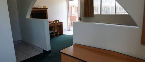 A room with a desk, chair, and a window.