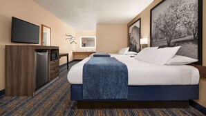 A hotel room with a bed, a desk with a flat-screen TV, a microwave, and a refrigerator. - Super 8 by Wyndham Lindsay Olive Tree (Lindsay)