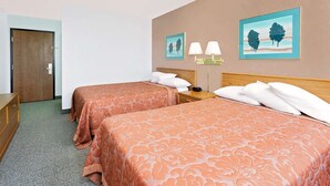 A hotel room with two beds, a wooden dresser, and two wall-mounted lamps. - Super 8 by Wyndham Cut Bank (Cut Bank)