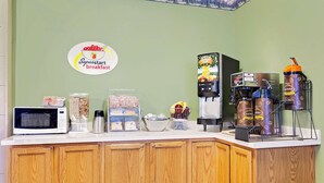 A breakfast bar with a microwave, coffee machine, and beverage dispensers. - Super 8 by Wyndham Cut Bank (Cut Bank)