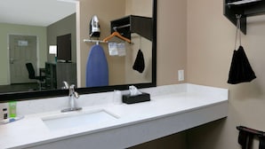A hotel bathroom with a large mirror, a sink, and a towel rack. - Super 8 by Wyndham Victoria / South / Hwy 59 (Victoria)