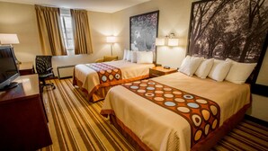 A hotel room with two beds, a desk, a TV, and a large window with curtains. - Super 8 by Wyndham State College (State College)