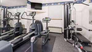A gym with treadmills, elliptical machines, and weight machines. - Super 8 by Wyndham State College (State College)