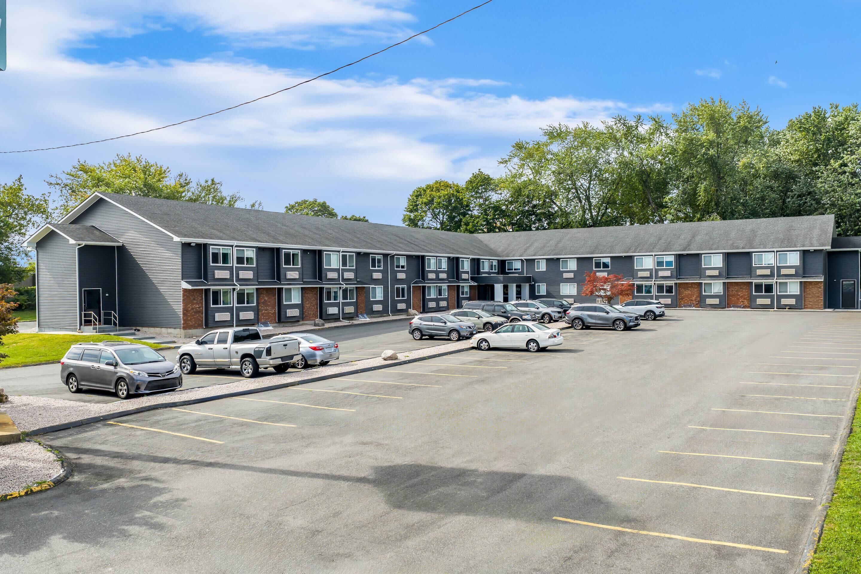 A multi-story hotel with a parking lot.