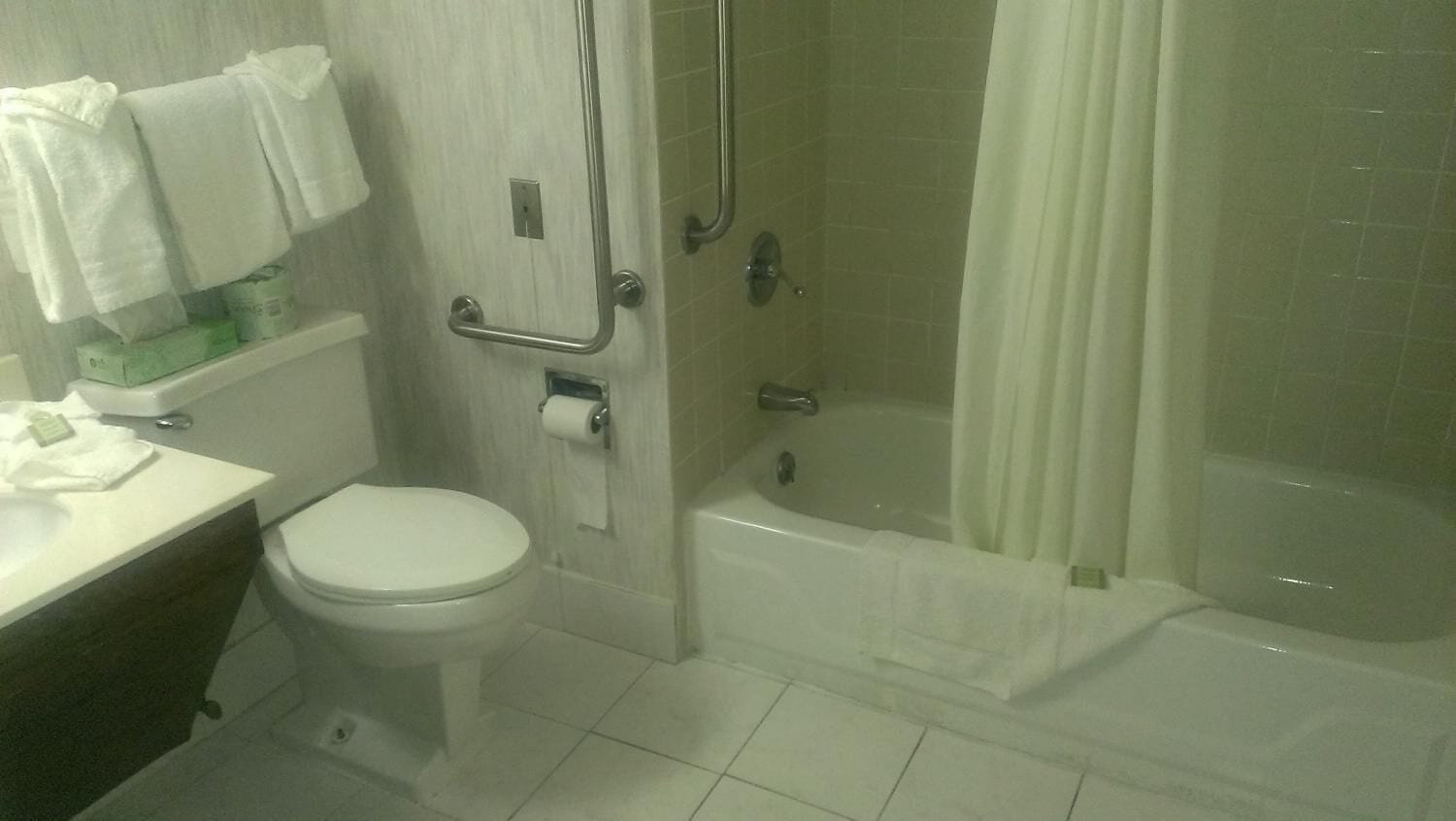 A bathroom with a toilet, a sink, a shower with a glass door, and a bathtub.