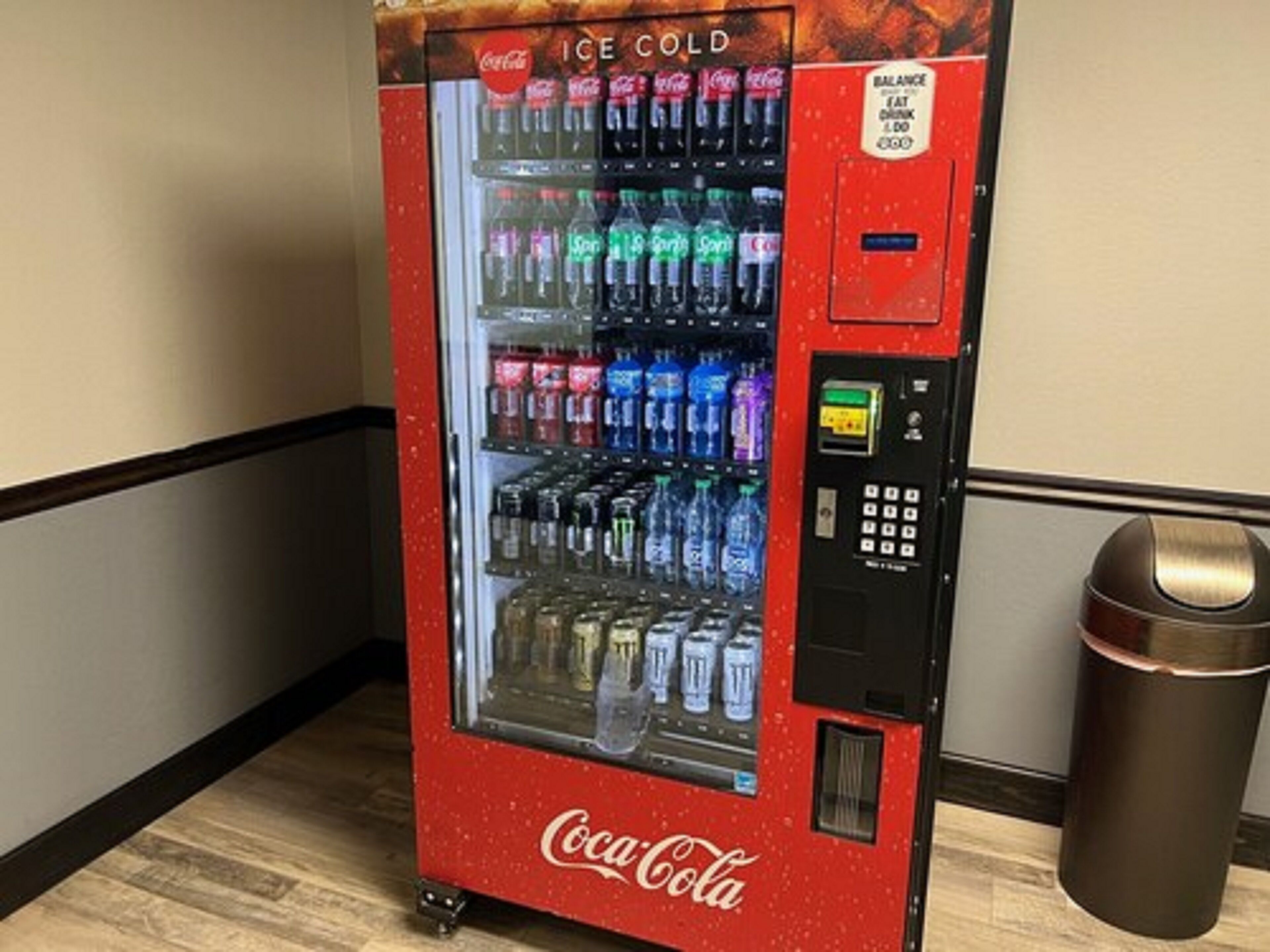 A Coca-Cola branded vending machine with an ice cold selection of beverages.