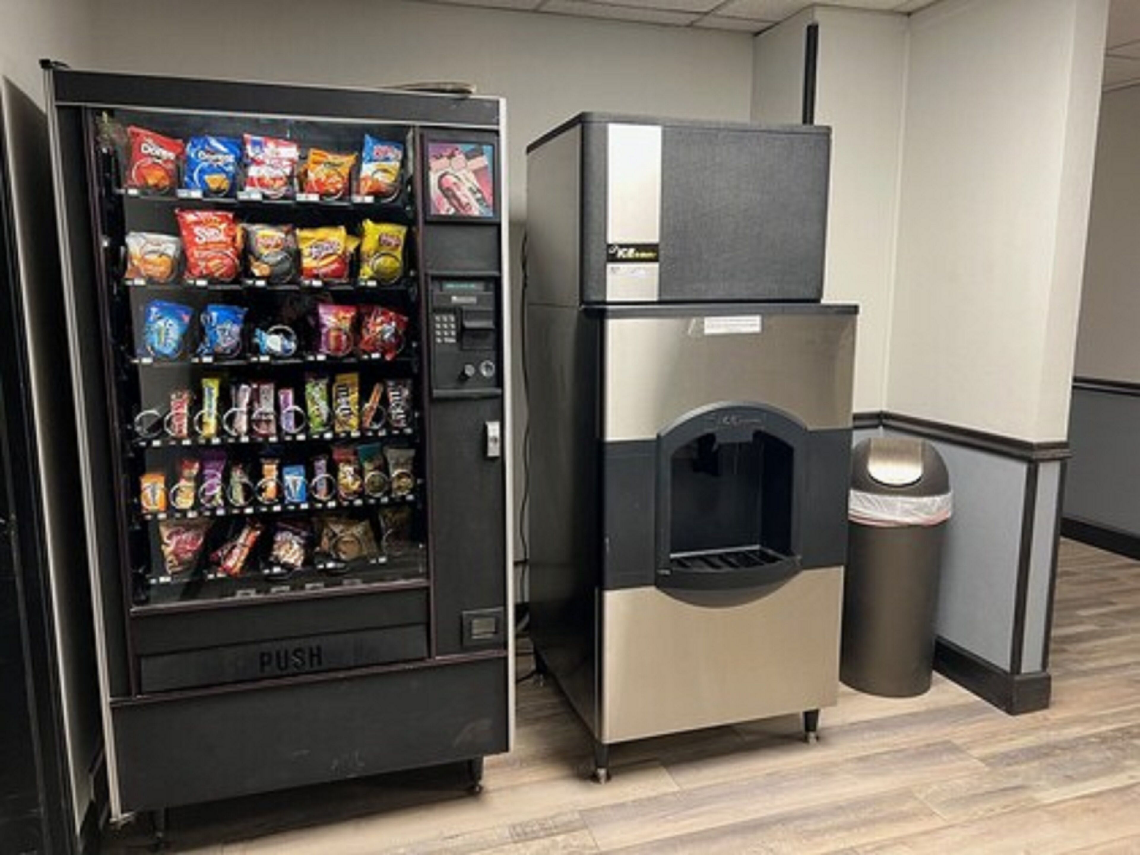 A vending machine with snacks and a push-button water dispenser.