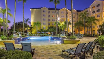 Alberca al aire libre, sombrillas en la alberca y camastros