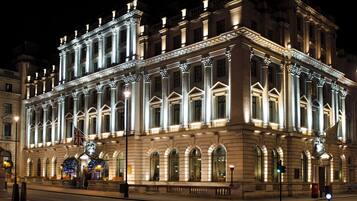 A historic building with classical architecture, featuring a symmetrical facade, large windows, and ornate detailing.