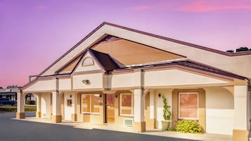 A two-story building with a flat roof and a central entrance.