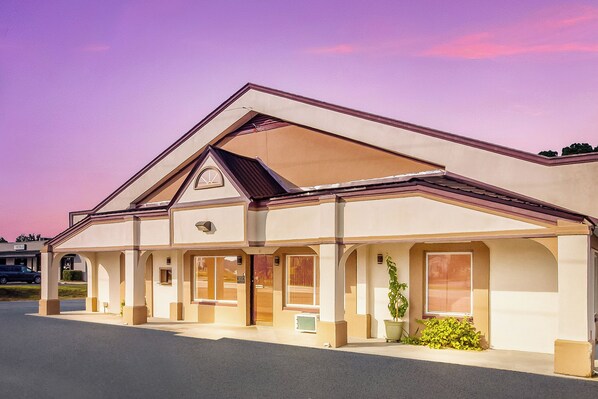 A two-story building with a flat roof and a central entrance.