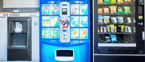 A vending machine with various snacks and drinks, including Pepsi, and a water dispenser labeled 'Ice Cubes'.