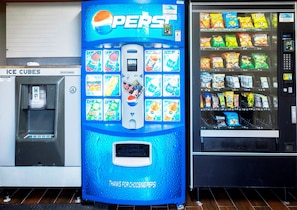 A vending machine with various snacks and drinks, including Pepsi, and a water dispenser labeled 'Ice Cubes'.