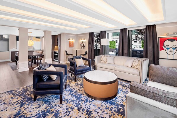 A modern hotel lobby with a dining area, seating arrangements, and a large window providing a view of the city.