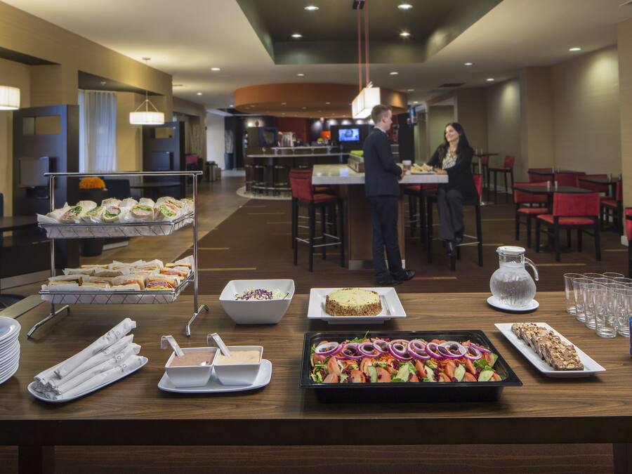A buffet setup with various food items and beverages.