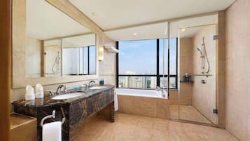 A modern bathroom with two sinks, a large mirror, and a glass-enclosed shower.