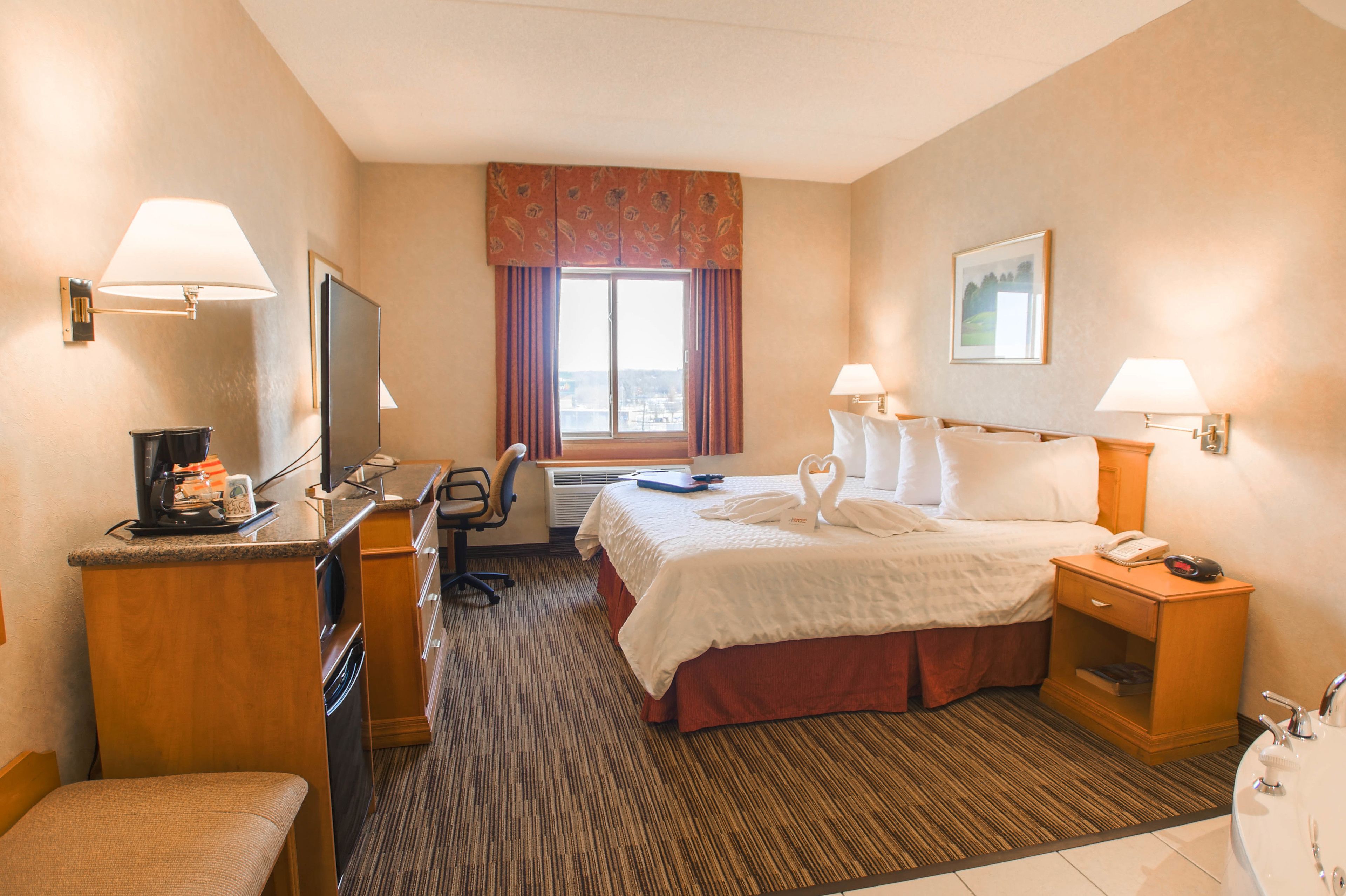 room, 1 king bed, jetted tub | living area | 45-inch flat-screen tv with cable channels, tv