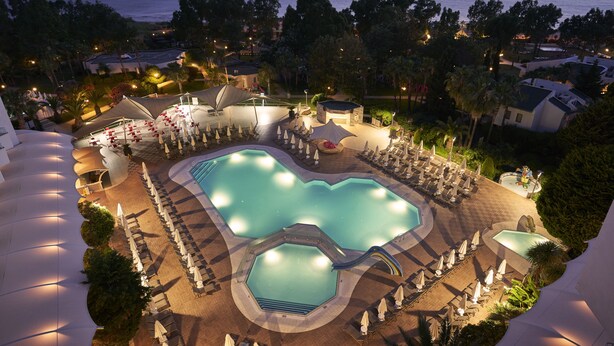 A resort pool area with multiple swimming pools, sun loungers, and umbrellas. - Richmond Ephesus Resort - All Inclusive (Selçuk)