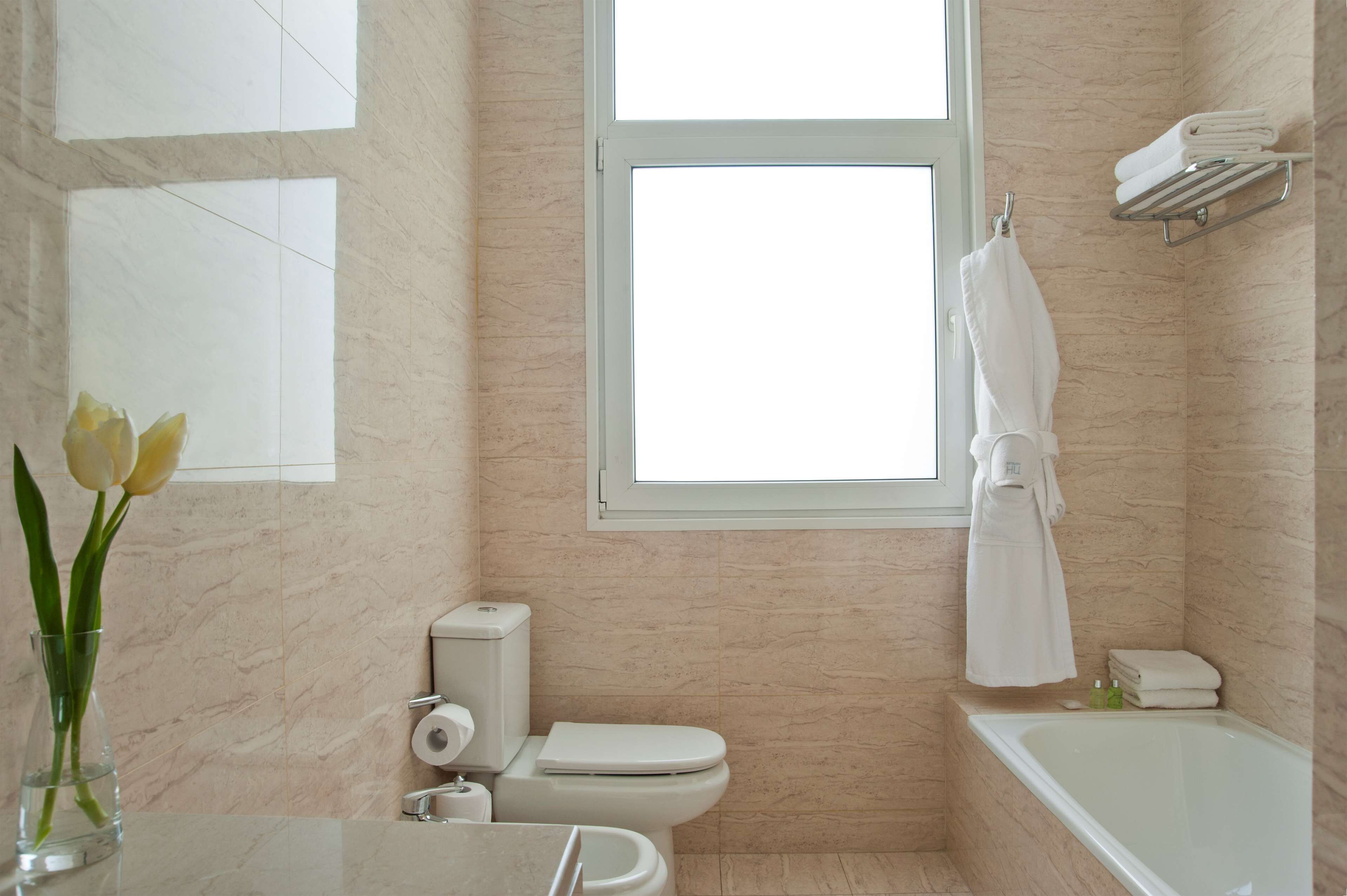 deep-soaking bathtub, rainfall showerhead, eco-friendly toiletries