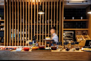 A buffet area with various food and drink options, including a selection of cheeses, spreads, and sauces. - Holiday Inn Express Logrono Rioja by IHG (Logroño)