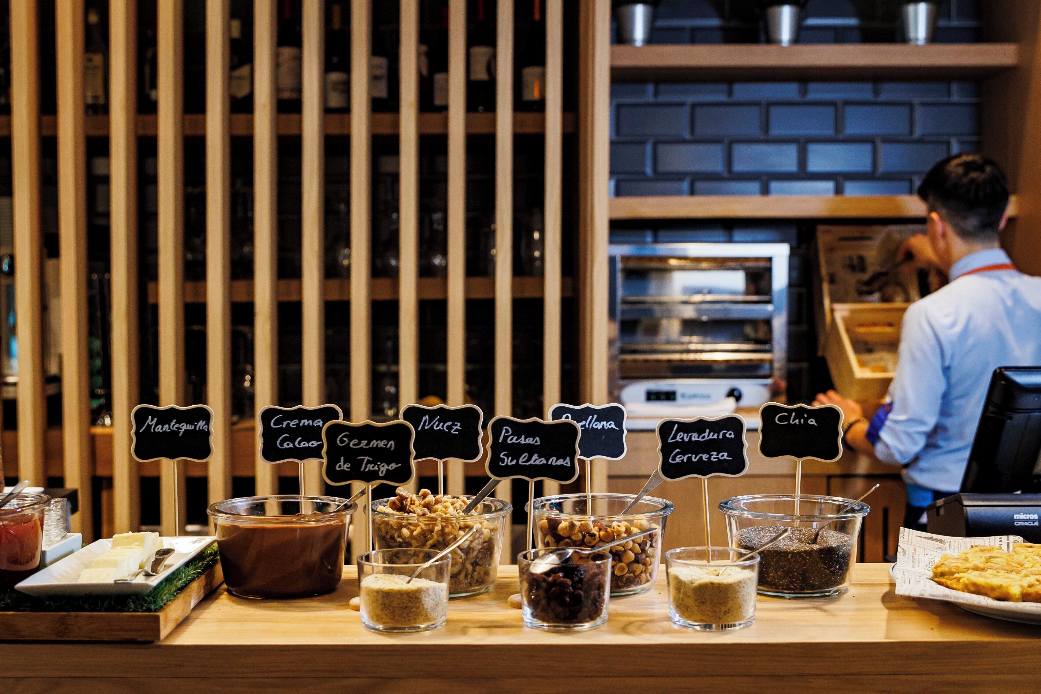 A breakfast buffet with various food items and labels.