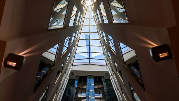 A modern building with a central glass ceiling and multiple floors. - Holiday Inn Express Logrono Rioja by IHG (Logroño)