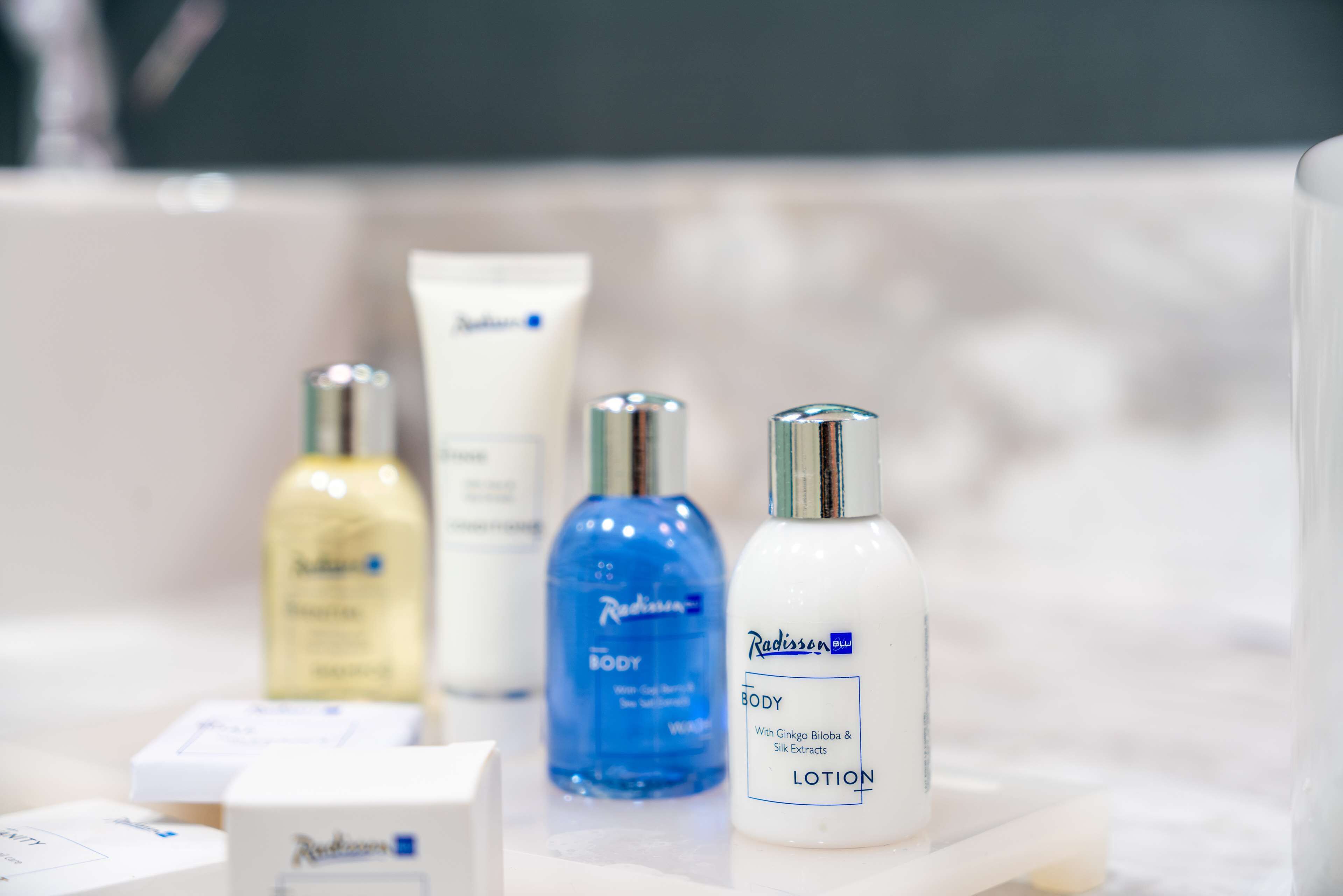 A bathroom with various skincare products on a shelf.