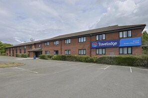 A Travelodge hotel with a brick facade, multiple windows, and a sign indicating the location as Bristol Severn View M48. - Travelodge Bristol Severn View M48 (Bristol)