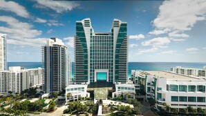 A high-rise hotel with a central atrium, multiple floors, and a view of the ocean. - Signia by Hilton Diplomat Beach Resort (Hollywood)