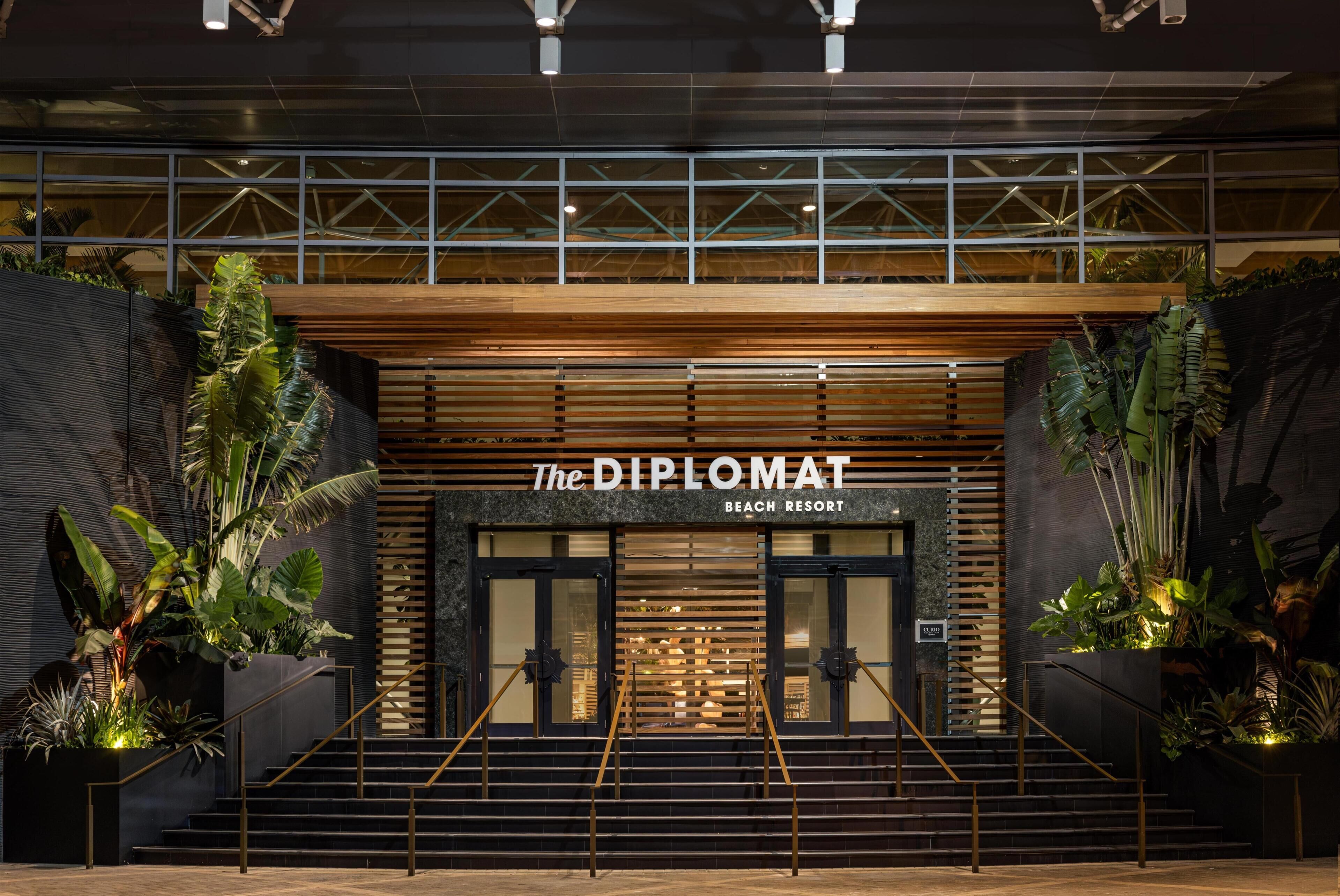 Une entrée moderne d’un bâtiment, avec une enseigne indiquant : « The Diplomat Beach Resort ».