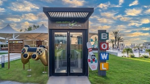 A building labeled "GAME CENTER" with a bowling sign nearby. -  Mirage Park Resort - Premium All Inclusive (Kemer)